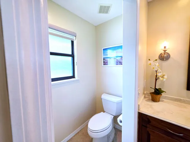 a room with painting on the wall and a potted plant