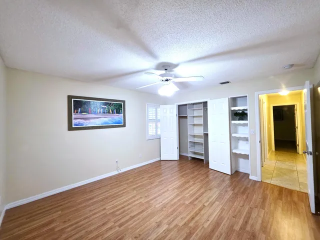 a spacious bathroom with a granite countertop sink and a mirror