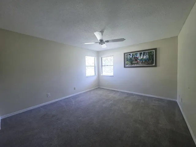 a view of an empty room with a fan