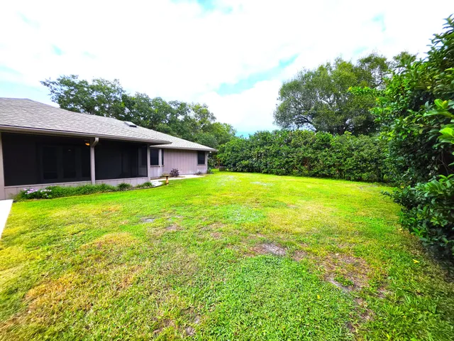 a view of pool with a yard