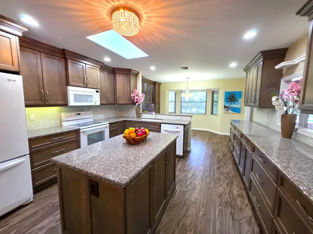 a kitchen with a stove sink and a refrigerator