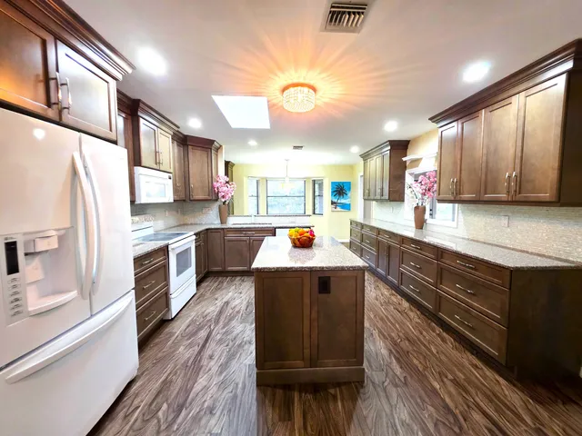 a large white kitchen with a large window
