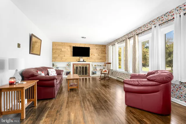 a living room with furniture fireplace and a flat screen tv
