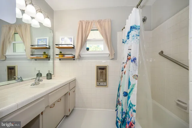 a bathroom with a sink a vanity and a mirror