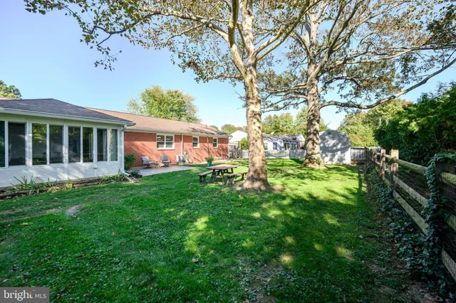 a view of a house with backyard porch and sitting area
