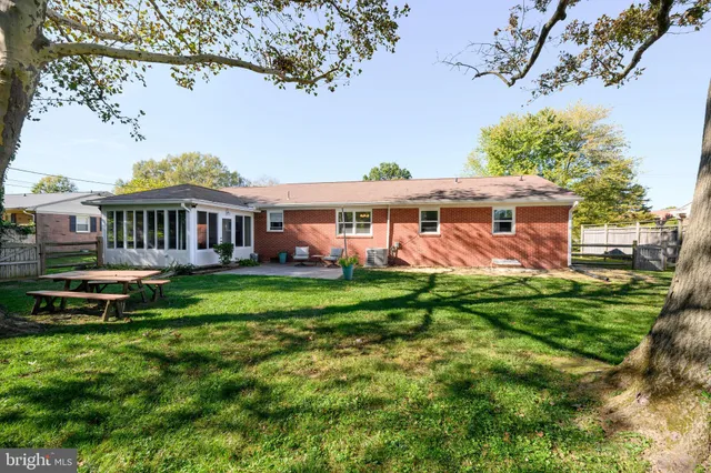 a view of a house with a yard table and chairs