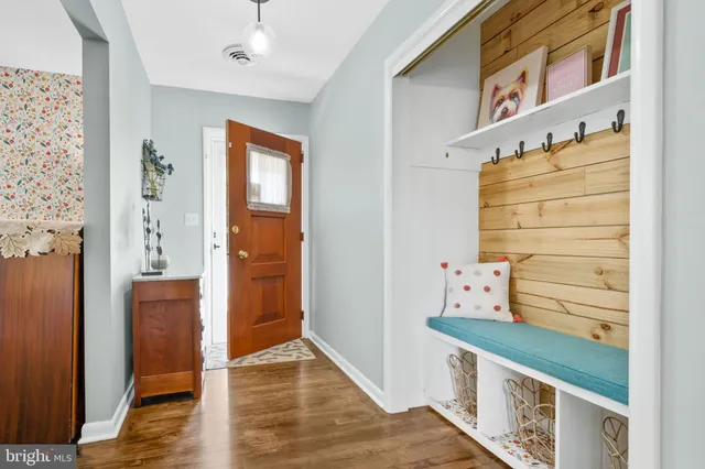 a view of a hallway with wooden floor and entryway