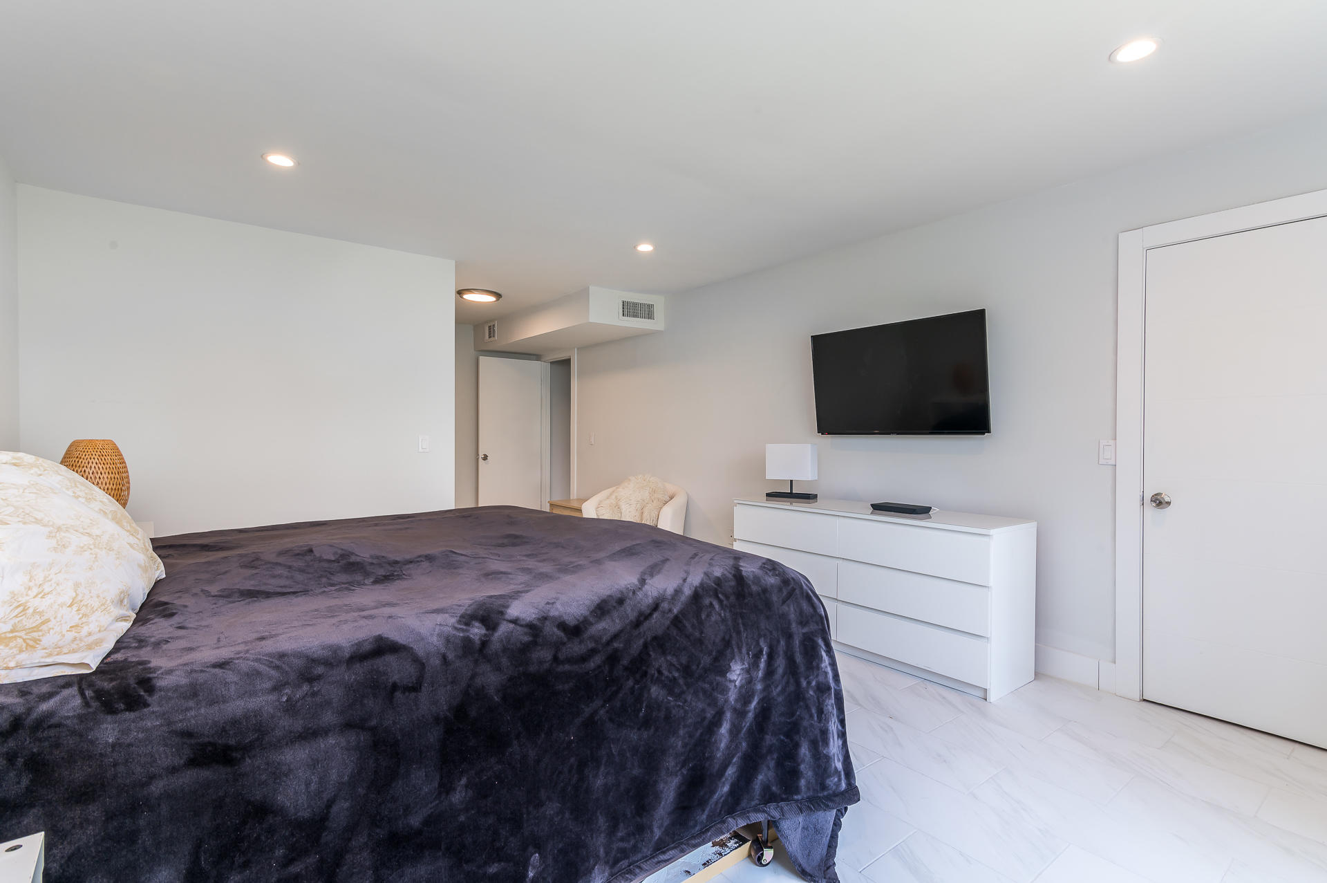 21856 Arriba Real, Unit 5E Boca Raton, FL 33433 - Photo 11 of 17 a bedroom with a bed and a flat screen tv