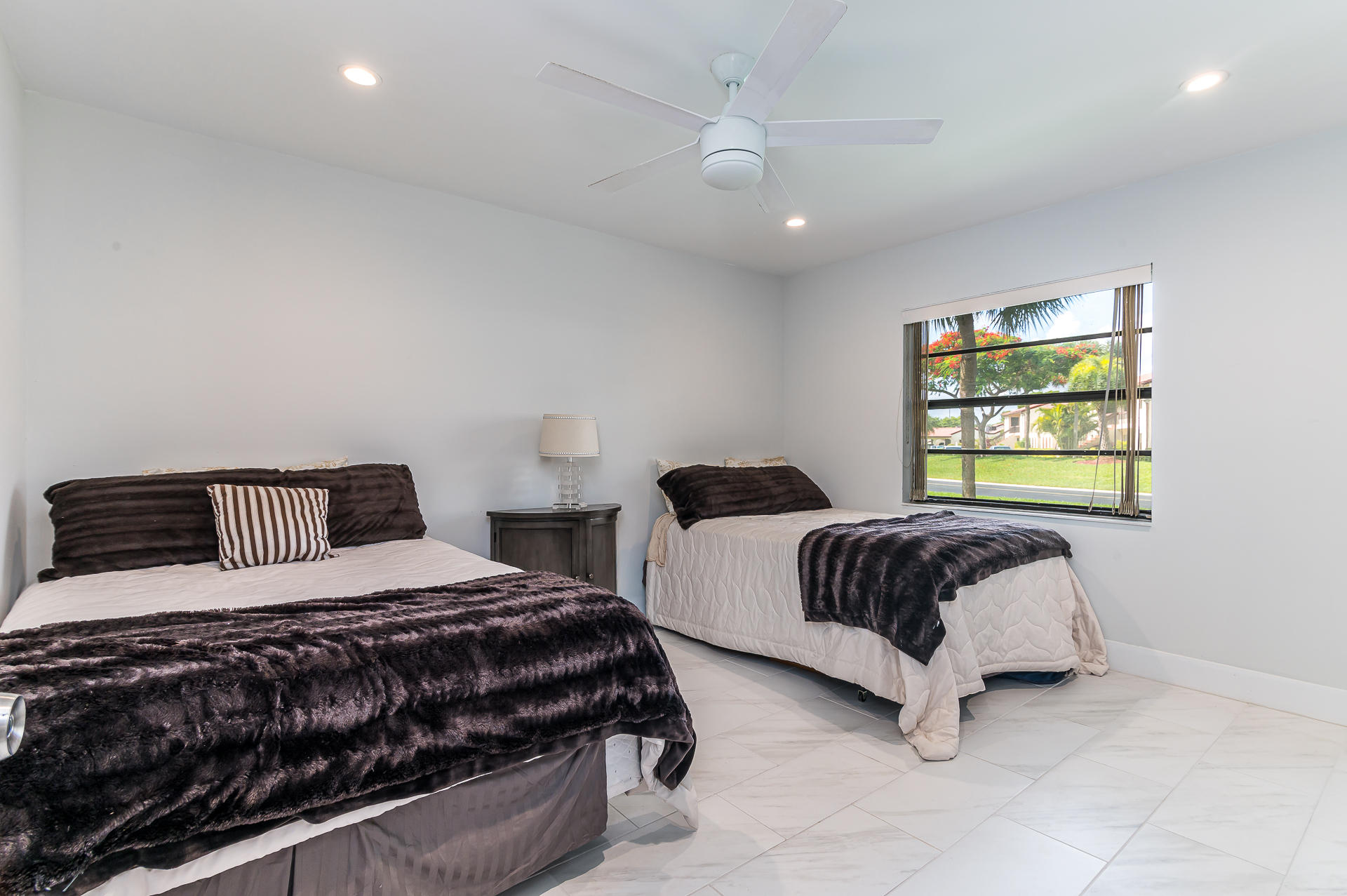 21856 Arriba Real, Unit 5E Boca Raton, FL 33433 - Photo 14 of 17 a bedroom with two beds and a window