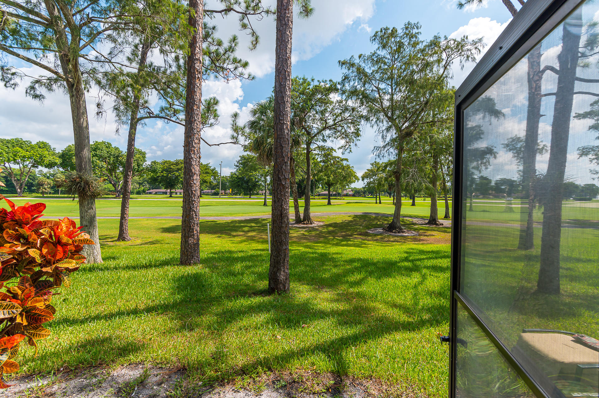 21856 Arriba Real, Unit 5E Boca Raton, FL 33433 - Photo 16 of 17 a view of a park with large trees