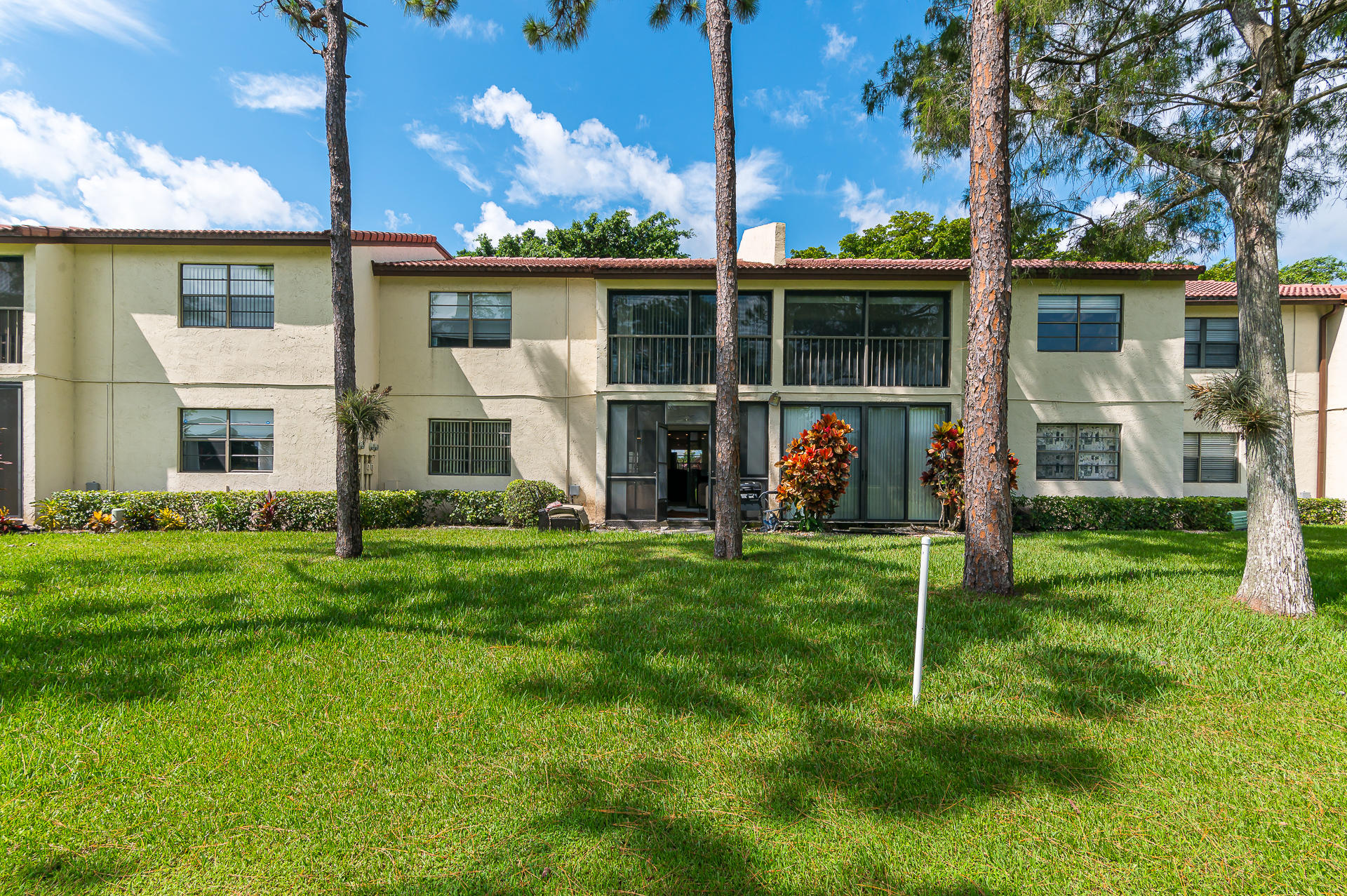 21856 Arriba Real, Unit 5E Boca Raton, FL 33433 - Photo 2 of 17 a view of a house with a yard and porch