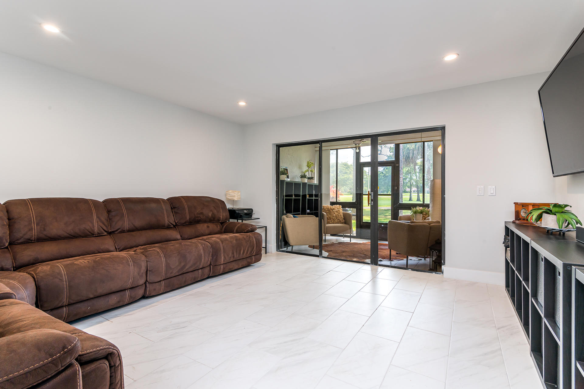 21856 Arriba Real, Unit 5E Boca Raton, FL 33433 - Photo 7 of 17 a living room with a couch and a large window
