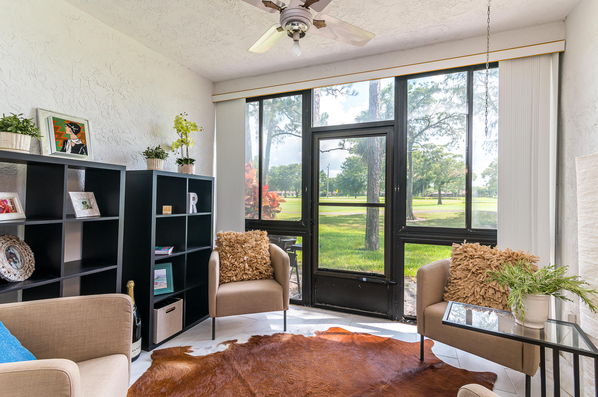 21856 Arriba Real, Unit 5E Boca Raton, FL 33433 - Photo 9 of 17 a living room with furniture and a floor to ceiling window