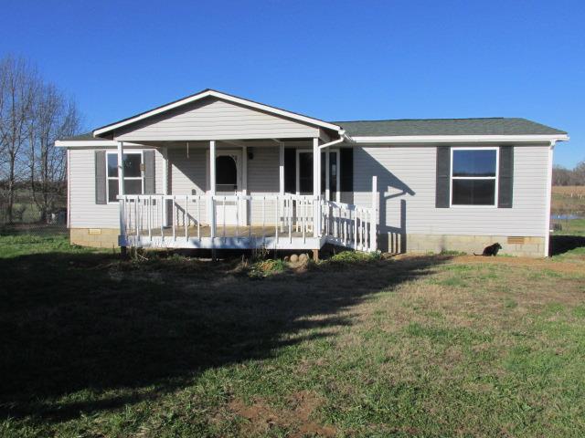 1660 Goforth Road Morrison, TN 37357 - Photo 1 of 11 a front view of a house with a garden