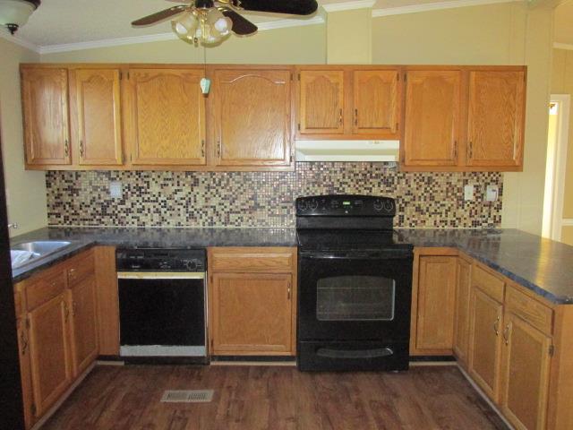 1660 Goforth Road Morrison, TN 37357 - Photo 3 of 11 a kitchen with stainless steel appliances wooden cabinets and a stove top oven