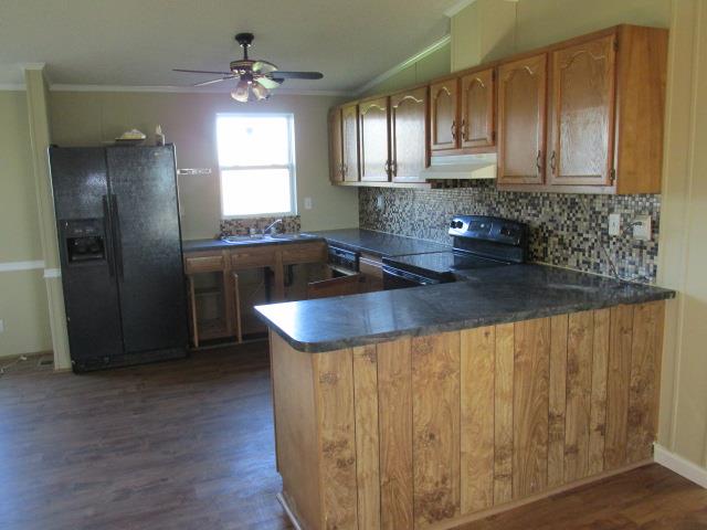 1660 Goforth Road Morrison, TN 37357 - Photo 4 of 11 a kitchen with stainless steel appliances granite countertop a sink window and cabinets