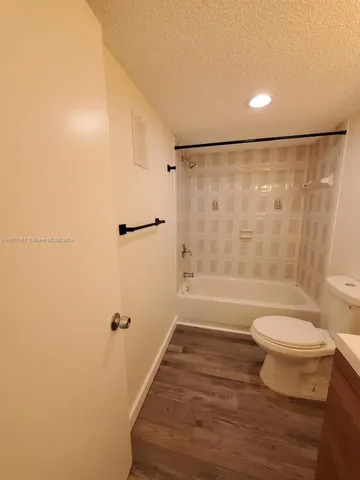 a bathroom with a shower a toilet and a sink