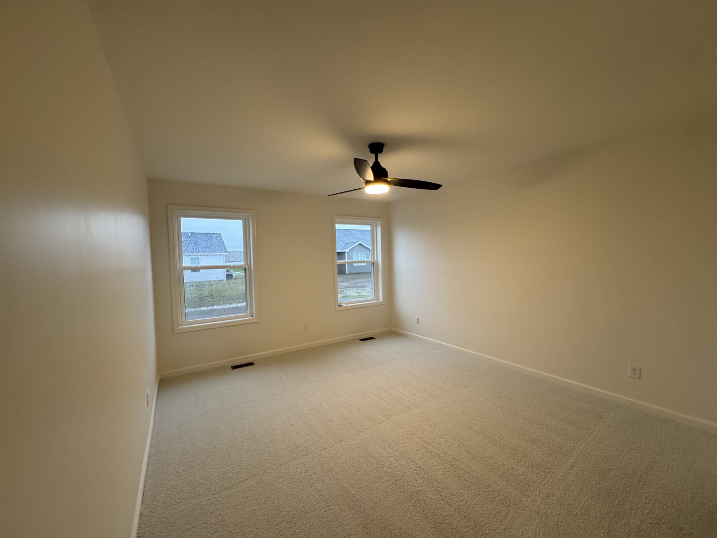 506 Patterson Drive Bloomington, IL 61701 - Photo 12 of 28 an empty room with windows and ceiling fan view