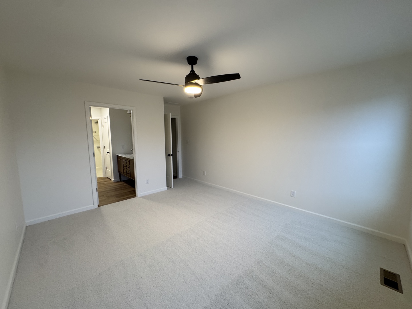 506 Patterson Drive Bloomington, IL 61701 - Photo 13 of 28 an empty room with chandelier fan and windows