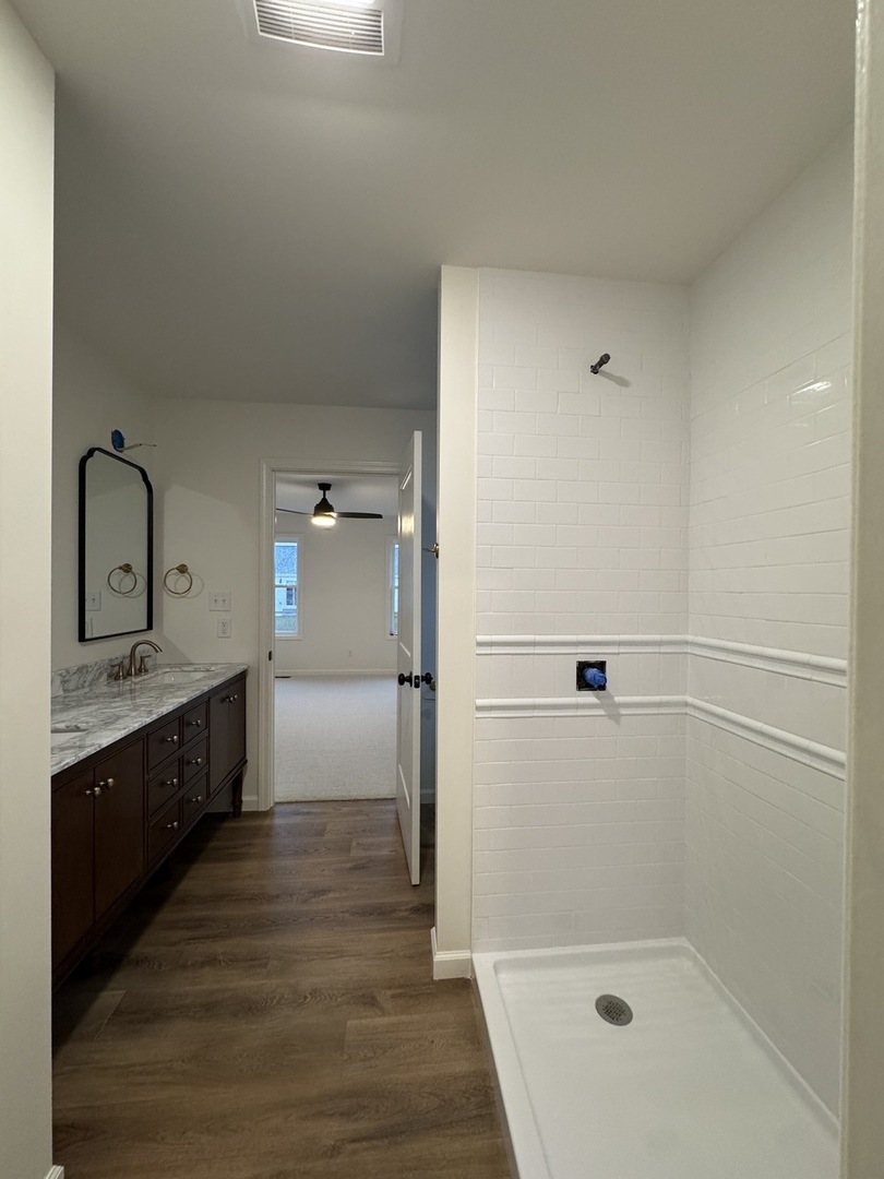 506 Patterson Drive Bloomington, IL 61701 - Photo 17 of 28 a bathroom with a granite countertop sink mirror and shower