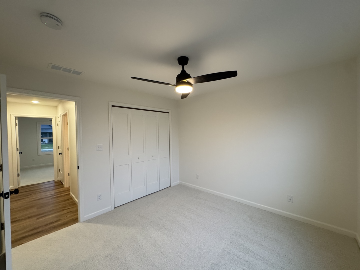 506 Patterson Drive Bloomington, IL 61701 - Photo 21 of 28 an empty room with closet and a ceiling fan