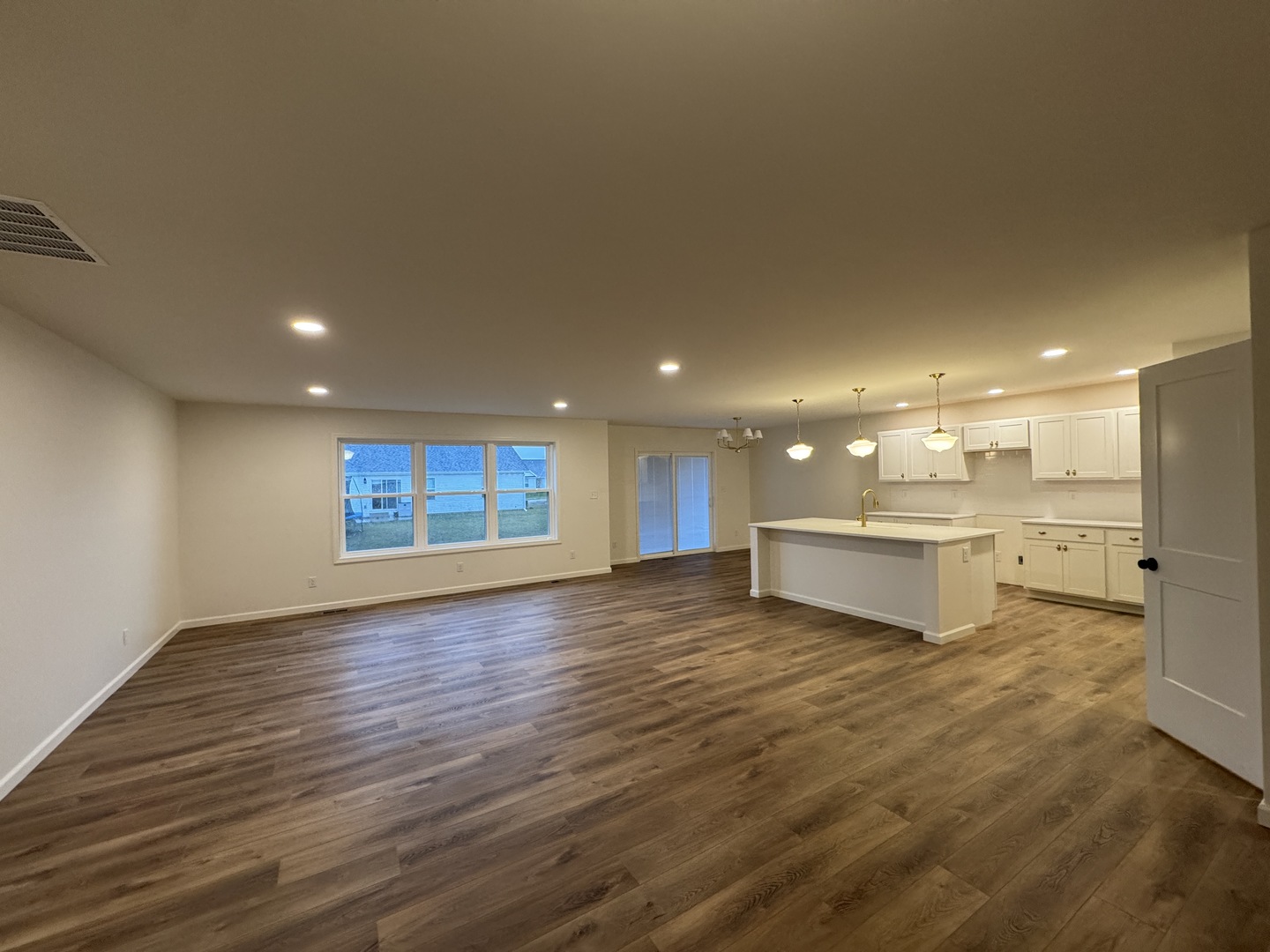 506 Patterson Drive Bloomington, IL 61701 - Photo 3 of 28 a view of a big room with wooden floor and windows