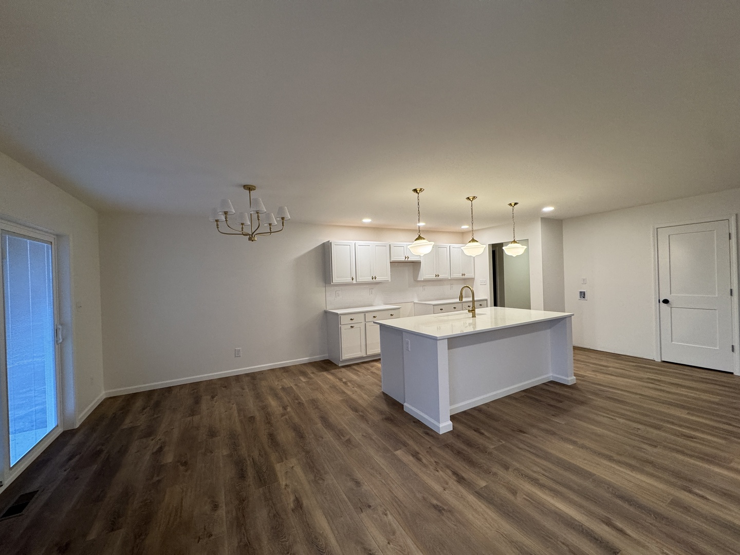 506 Patterson Drive Bloomington, IL 61701 - Photo 6 of 28 a large white kitchen with a sink dishwasher a refrigerator and white cabinets with wooden floor