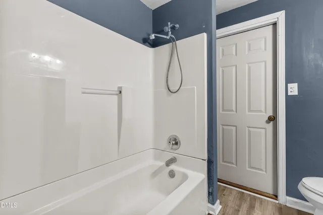 a bathroom with a bathtub a shower and a shower