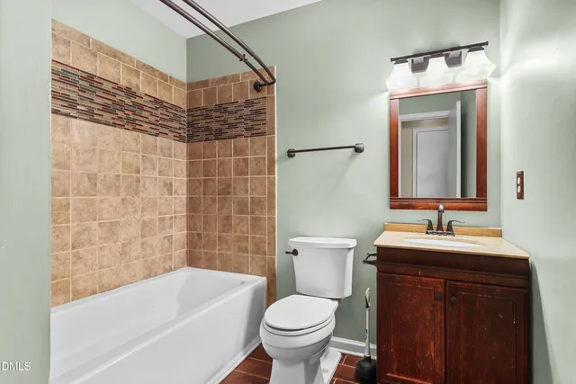 a bathroom with a sink and mirror with toilet