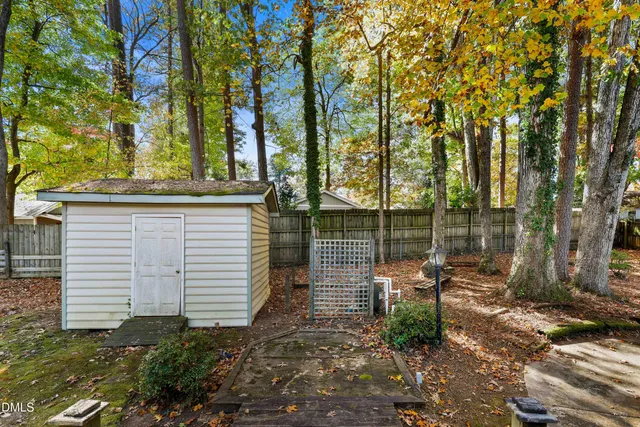 a view of a chair and table in the backyard
