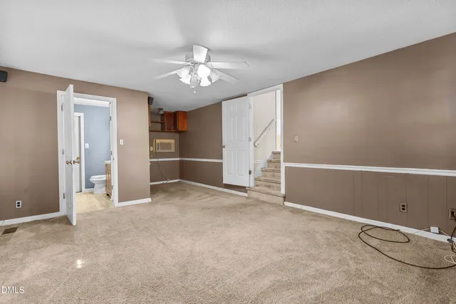 an empty room with closet and windows