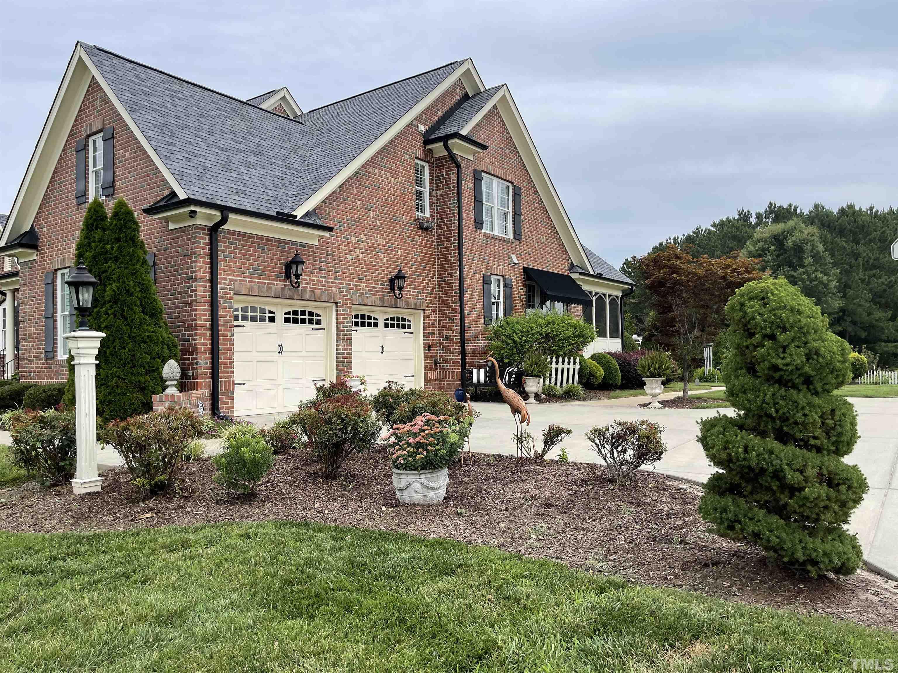 6228 Mitchell Mill Road Zebulon, NC 27597 - Photo 2 of 51 a view of a house with backyard and garden