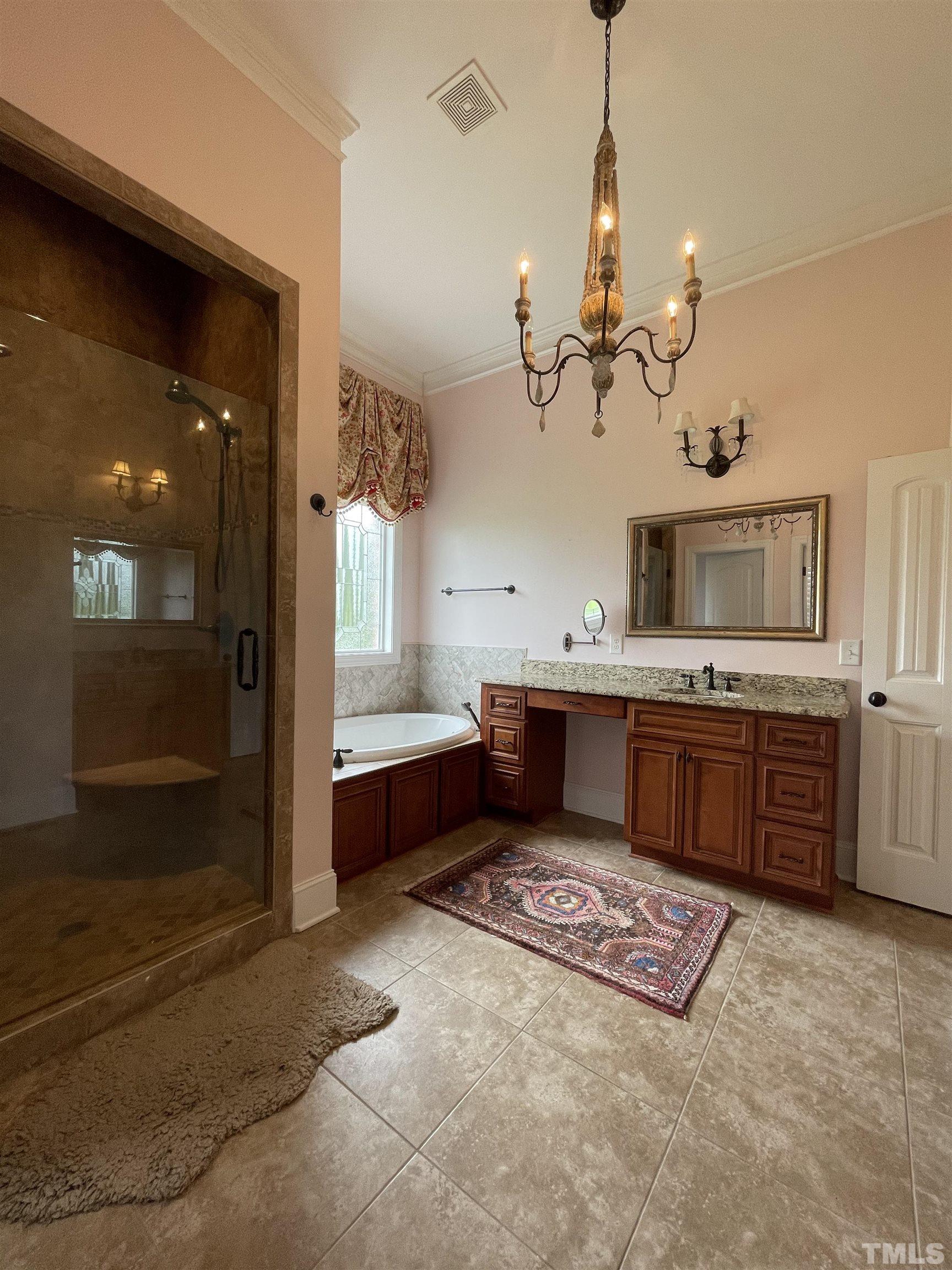 6228 Mitchell Mill Road Zebulon, NC 27597 - Photo 27 of 51 a bathroom with a tub sink and mirror