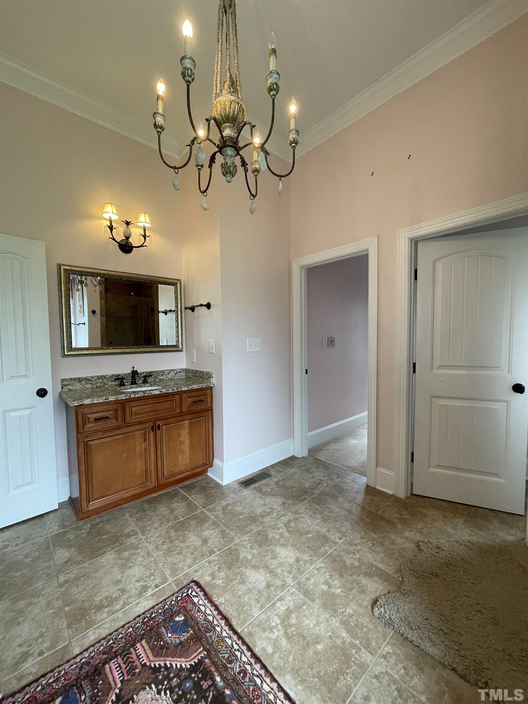 6228 Mitchell Mill Road Zebulon, NC 27597 - Photo 28 of 51 a view of a room with a fireplace and chandelier
