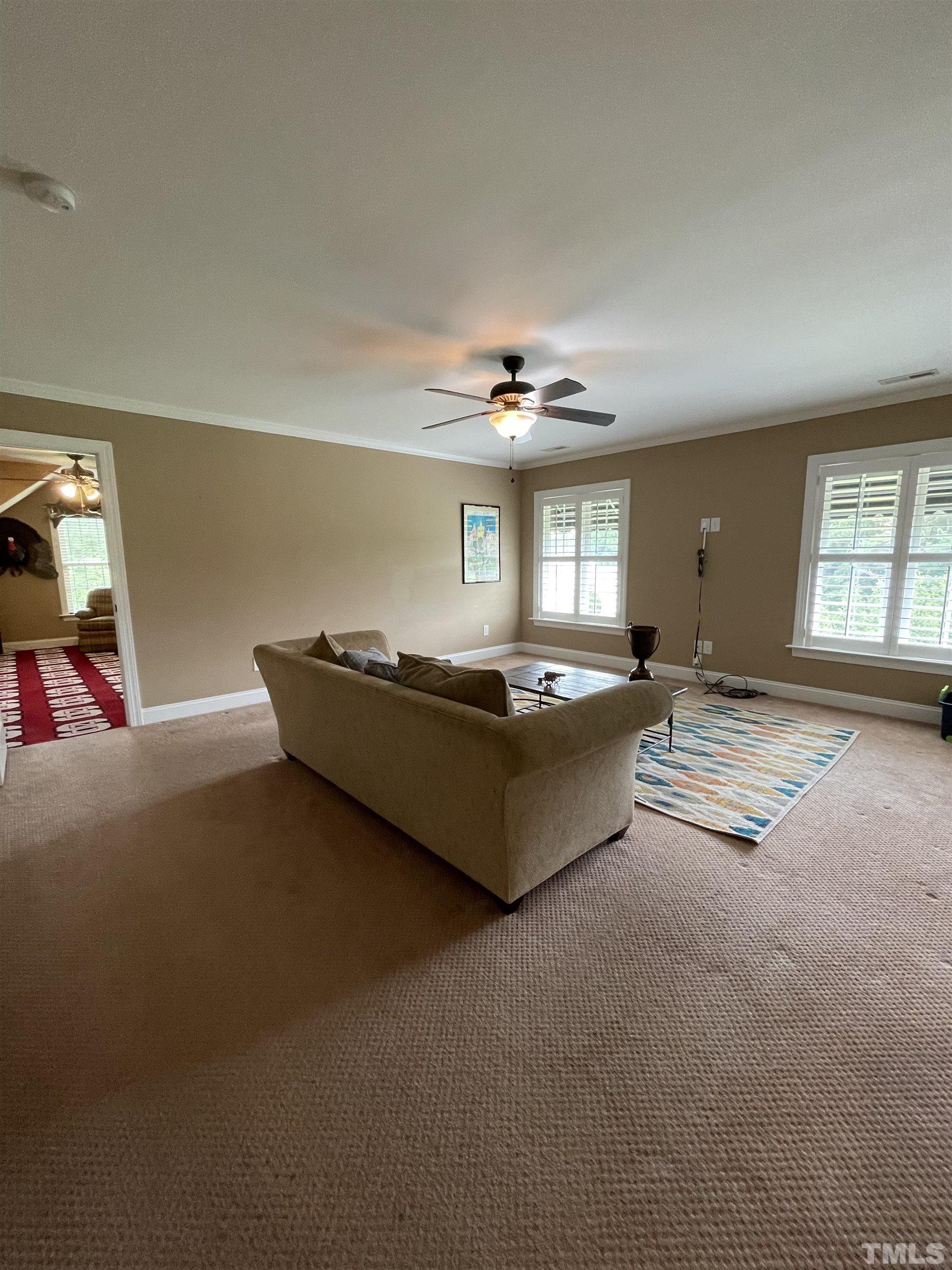 6228 Mitchell Mill Road Zebulon, NC 27597 - Photo 39 of 51 a living room with furniture and chandelier