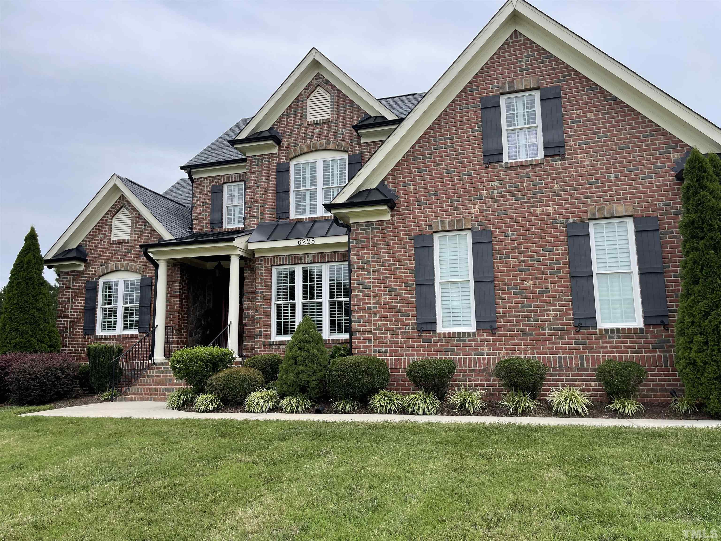 6228 Mitchell Mill Road Zebulon, NC 27597 - Photo 50 of 51 a front view of a house with a yard