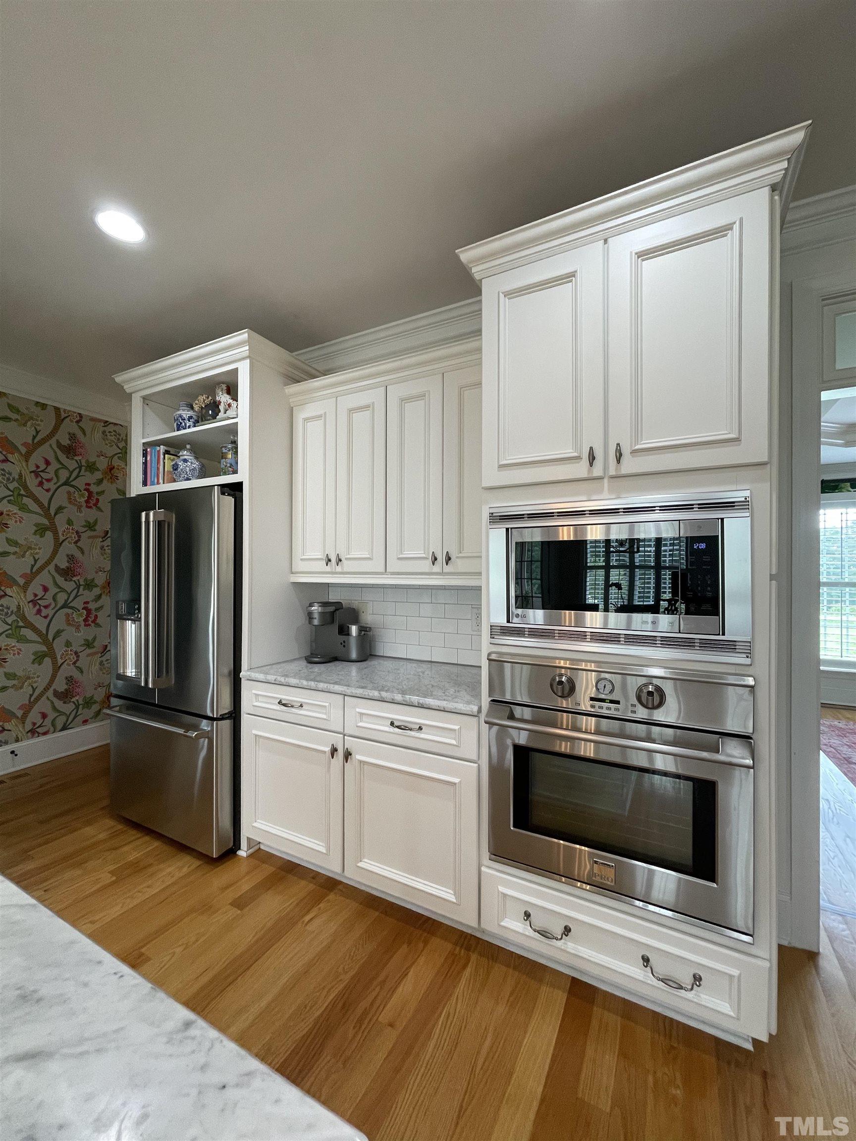 6228 Mitchell Mill Road Zebulon, NC 27597 - Photo 6 of 51 a kitchen with granite countertop a refrigerator stove and microwave