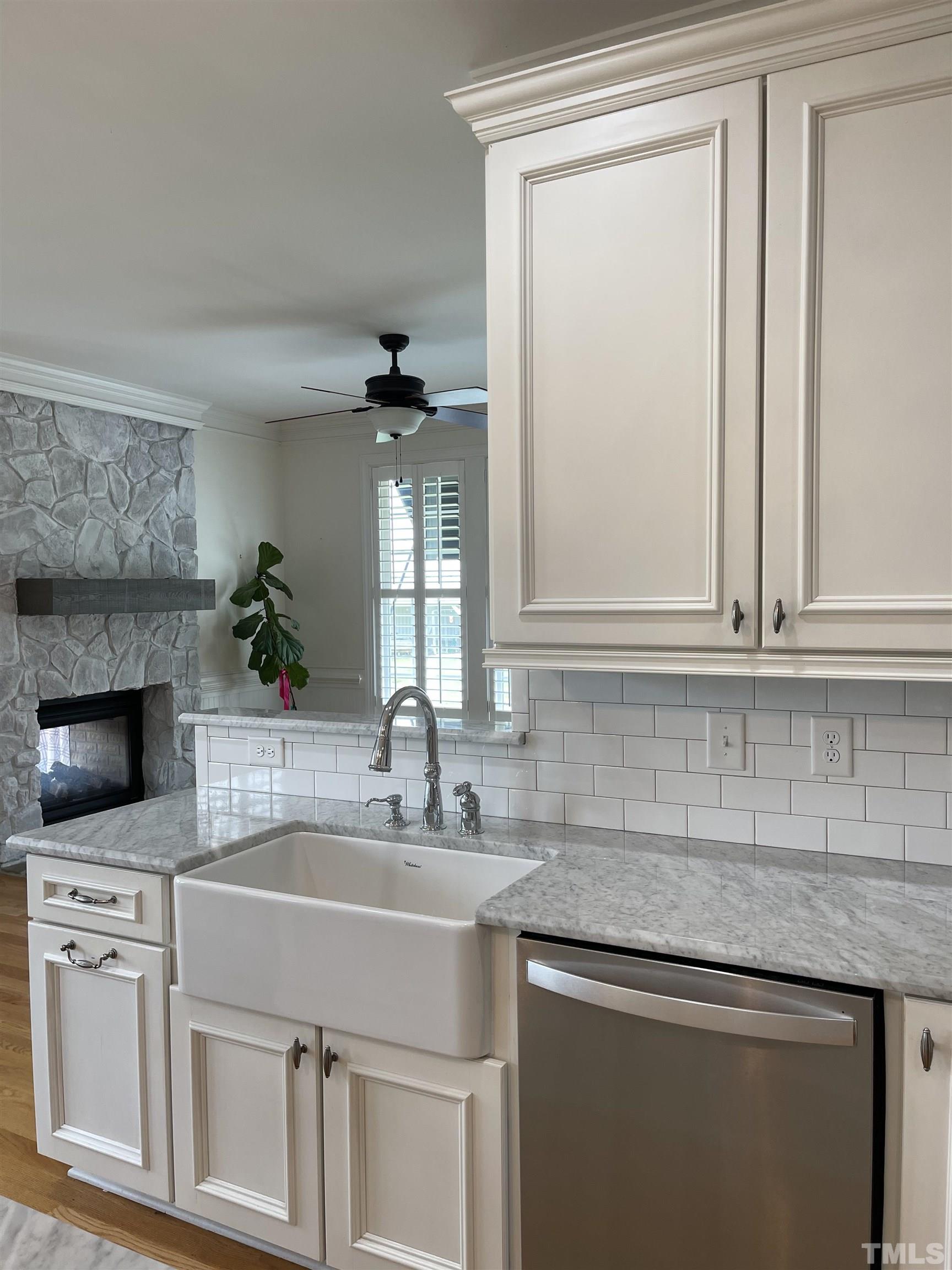 6228 Mitchell Mill Road Zebulon, NC 27597 - Photo 9 of 51 a kitchen with stainless steel appliances white cabinets and a sink