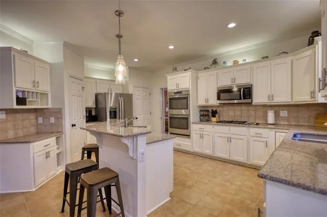 a kitchen with stainless steel appliances granite countertop a sink and cabinets