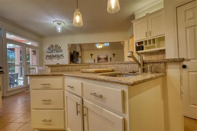 a living room with furniture a lamp and wooden floor