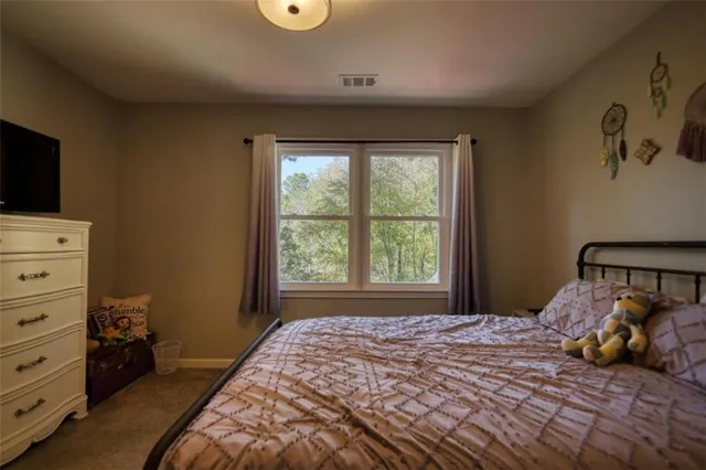 a bedroom with furniture and a flat screen tv