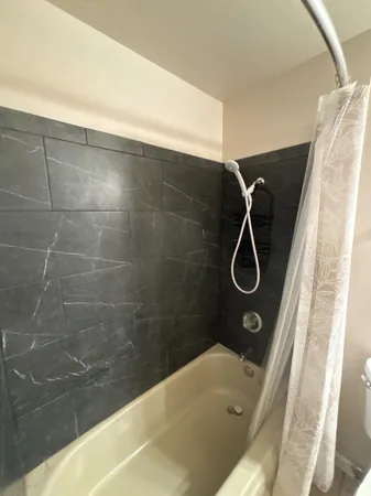 a bathroom with a granite countertop sink a toilet a mirror and vanity