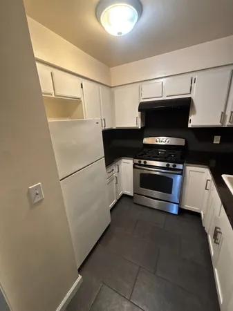 a kitchen with granite countertop a stove and a sink