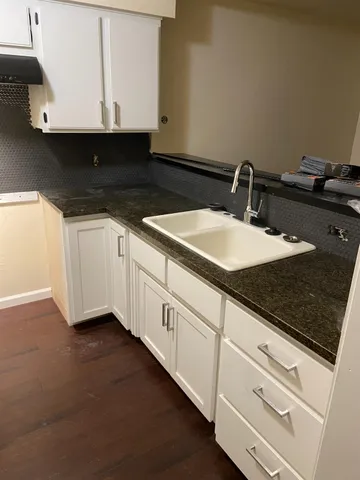 a kitchen with a sink and cabinets