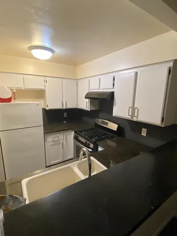 a kitchen with a sink and cabinets