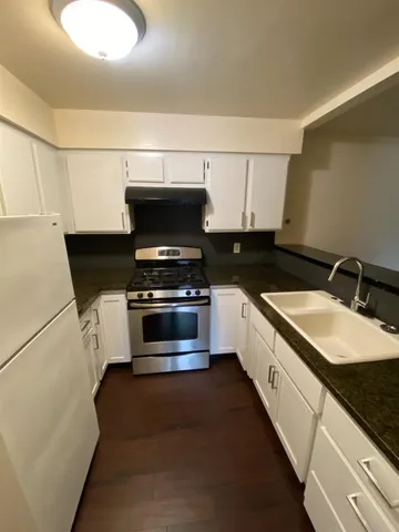 a kitchen with stainless steel appliances a stove a sink and a microwave