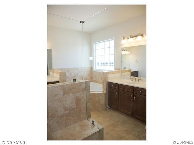 1246 Coalfield Road Midlothian, VA 23114 - Photo 5 of 5 a bathroom with a sink vanity granite tub shower and a mirror