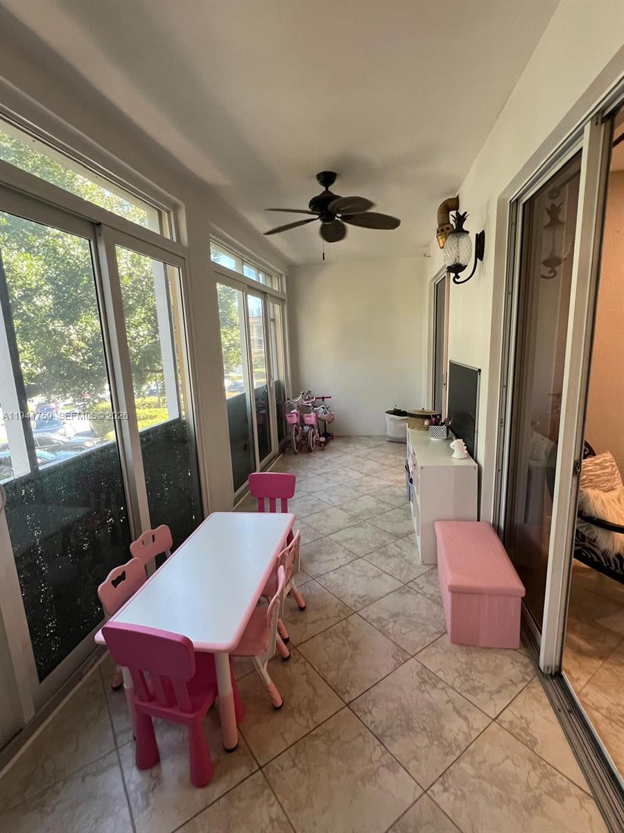 75 Gulfstream Road, Unit 211B Dania Beach, FL 33004 - Photo 20 of 57 a living room with furniture a window and a table