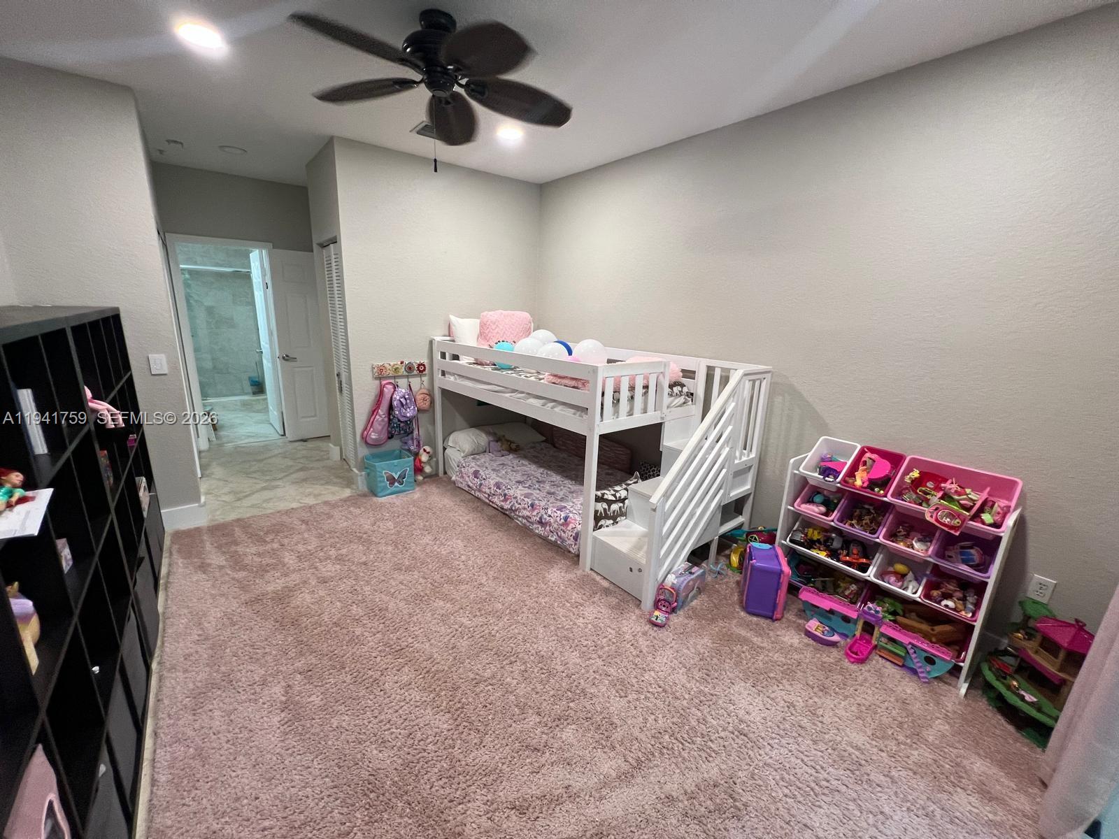 75 Gulfstream Road, Unit 211B Dania Beach, FL 33004 - Photo 23 of 57 a bedroom with furniture and a flat screen tv