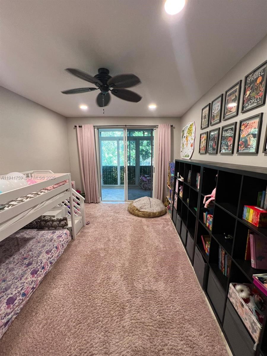 75 Gulfstream Road, Unit 211B Dania Beach, FL 33004 - Photo 24 of 57 a bedroom with a bed a large window and book shelf